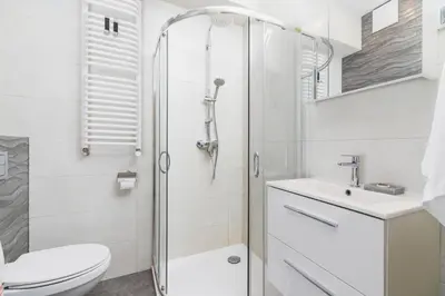 a bathroom with a shower and a toilet and a sink at Studios Lubelska Kraków by Noclegi Renters in Kraków