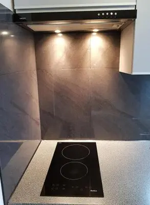 a black stove top oven in a kitchen at Cozy modern Apartment ASTORIA MAGIC GREY OLD TOWN in Kraków