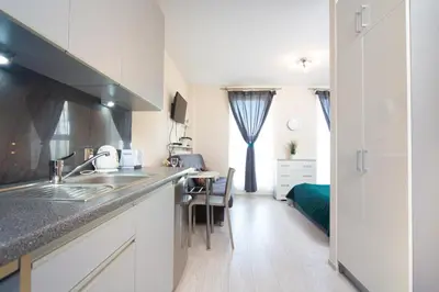 a kitchen with a sink and a counter top at Cozy modern Apartment ASTORIA MAGIC GREY OLD TOWN in Kraków