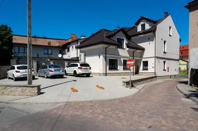a street with parked cars and a stop sign at Carp&Bed Zator in Zator