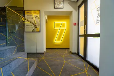 a hallway with a yellow door and stairs at Carp&Bed Zator in Zator