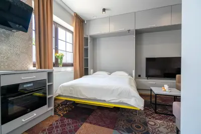 a bedroom with a bed and a flat screen tv at Carp&Bed Zator in Zator