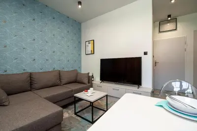 a living room with a couch and a flat screen tv at Carp&Bed Zator in Zator