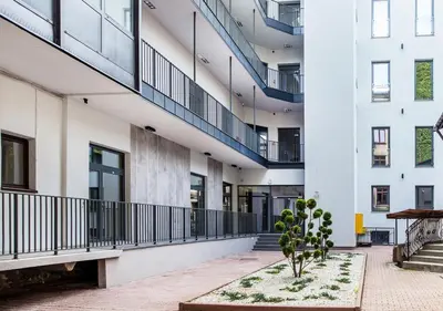 a courtyard in a building with a potted plant at Aparthotel Cracovia Residence in Kraków