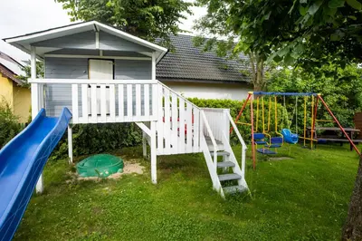 a play house with a slide and a playground at Orawskie Wyrko in Zubrzyca Górna