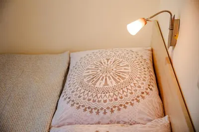 a bed with a lamp on top of it at Orawskie Wyrko in Zubrzyca Górna