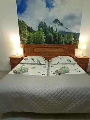 a bedroom with a bed with a view of a mountain at Nad Strumykiem in Mszana Dolna