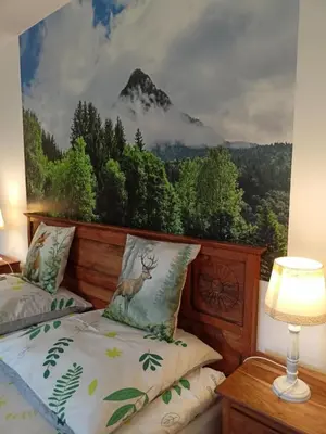 a bedroom with two beds and a mountain mural at Nad Strumykiem in Mszana Dolna