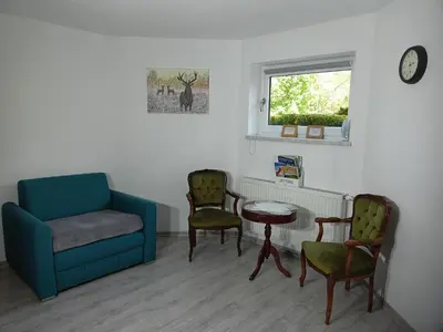 a living room with a couch and chairs and a table at Nad Strumykiem in Mszana Dolna