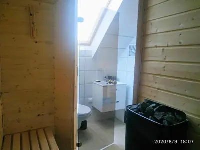 a bathroom with a toilet and a sink and a window at Górskie Marzenie - apartament w spokojnej okolicy z sauną blisko energylandii in Przeciszów