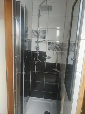 a shower with a glass door in a bathroom at Górskie Marzenie - apartament w spokojnej okolicy z sauną blisko energylandii in Przeciszów
