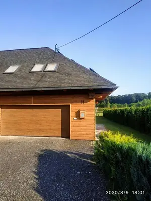 a building with a garage with a roof at Górskie Marzenie - apartament w spokojnej okolicy z sauną blisko energylandii in Przeciszów
