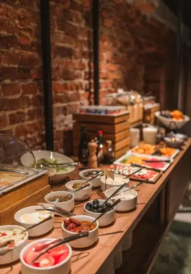 a buffet line with many different types of food at Hotel Estera in Kraków