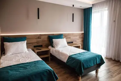 a bedroom with two beds and a window at Hotel Rancho Pcim in Pcim
