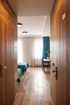 a bedroom with a bed and a window and a door at Hotel Rancho Pcim in Pcim