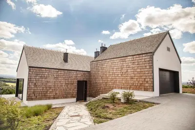 a house with a brick wall at villa relax with swimming pool and mountain view in Buków