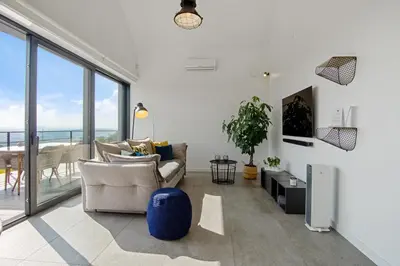 a living room with a couch and a large window at villa relax with swimming pool and mountain view in Buków