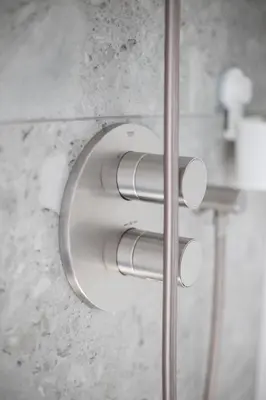 a toilet paper holder on the wall of a bathroom at villa relax with swimming pool and mountain view in Buków
