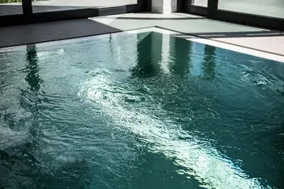 a swimming pool with green water in a house at villa relax with swimming pool and mountain view in Buków