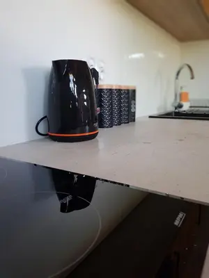 a black tea kettle sitting on a counter top at Kameralny in Przeciszów