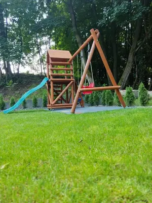 a playground in a park with a swing at Kameralny in Przeciszów
