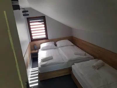 two twin beds in a room with a window at Kameralny in Przeciszów
