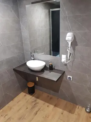 a bathroom with a sink and a mirror at Kameralny in Przeciszów