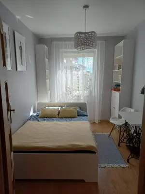 a bedroom with a bed and a window at W Krakowie u Helenki in Kraków