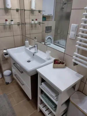 a bathroom with a sink and a mirror at W Krakowie u Helenki in Kraków
