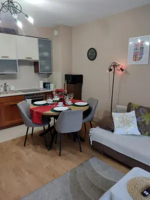 a living room with a table and a couch at W Krakowie u Helenki in Kraków