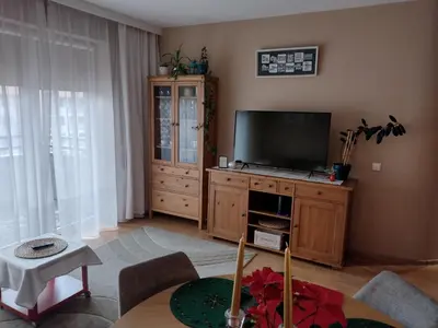 a living room with a television on a wooden cabinet at W Krakowie u Helenki in Kraków