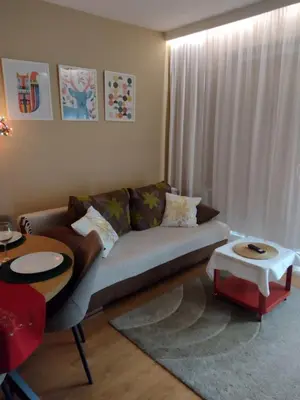 a living room with a couch and a table at W Krakowie u Helenki in Kraków