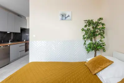 a bedroom with a bed with a plant on it at Cozy modern Apartment ASTORIA MAGIC ORANGE OLD TOWN in Kraków