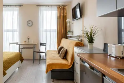 a kitchen and living room in a small apartment at Cozy modern Apartment ASTORIA MAGIC ORANGE OLD TOWN in Kraków