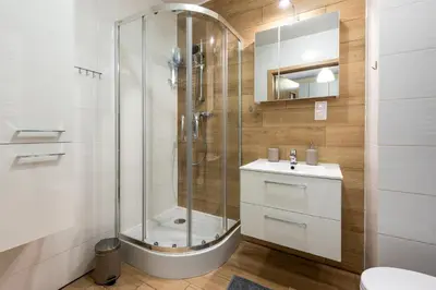 a bathroom with a shower and a sink and a toilet at Cozy modern Apartment ASTORIA MAGIC ORANGE OLD TOWN in Kraków