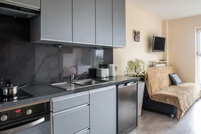 a kitchen with a sink and a counter top at Cozy modern Apartment ASTORIA MAGIC ORANGE OLD TOWN in Kraków