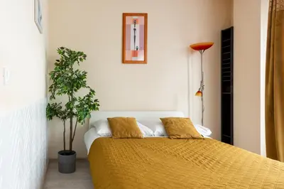 a bedroom with a bed with two pillows on it at Cozy modern Apartment ASTORIA MAGIC ORANGE OLD TOWN in Kraków
