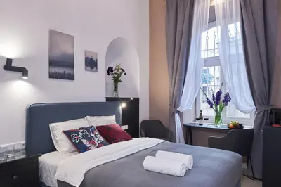 a bedroom with a bed with two towels on it at 7 HEAVEN Elegant Rooms KRAKÓW Old Town in Kraków