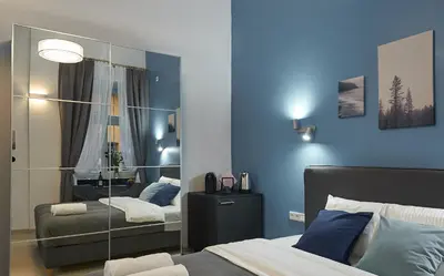 a bedroom with two beds and a mirror at 7 HEAVEN Elegant Rooms KRAKÓW Old Town in Kraków