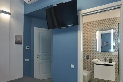 a bathroom with blue walls and a sink and a toilet at 7 HEAVEN Elegant Rooms KRAKÓW Old Town in Kraków