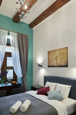 a bedroom with a bed with two pillows on it at 7 HEAVEN Elegant Rooms KRAKÓW Old Town in Kraków