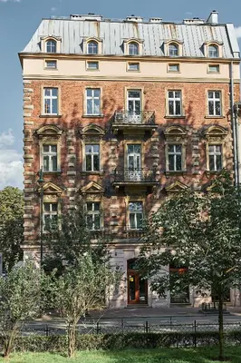 a large brick building with a metal roof at 7 HEAVEN Elegant Rooms KRAKÓW Old Town in Kraków