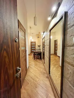 a hallway with a door and a table in a room at Cozy rooms in Old Town and Wawel in Kraków