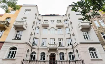 a large white building with balconies on it at Cozy rooms in Old Town and Wawel in Kraków