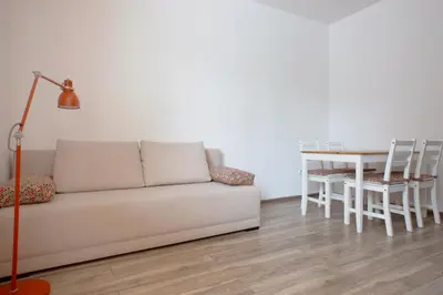a living room with a couch and a table at Apartament z ogrodem w centrum Limanowej in Limanowa