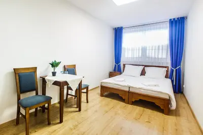 a bedroom with a bed and a table and a chair at BABIOGÓRSKA B&B in Zubrzyca Górna