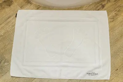 a white towel with footprints on it on a table at BABIOGÓRSKA B&B in Zubrzyca Górna