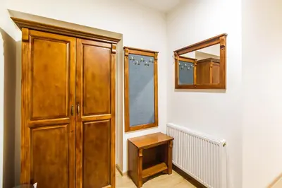 a room with a wooden cabinet and a mirror at BABIOGÓRSKA B&B in Zubrzyca Górna