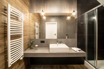 a bathroom with a sink and a mirror at Ostoja Garden in Brody