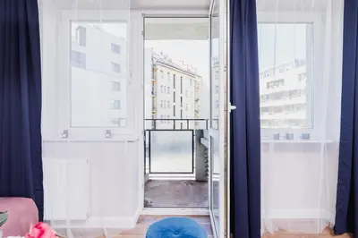 a room with a large glass door with a window at Apartament przy Bulwarach Wiślanych Kościuszki by Noclegi Renters in Kraków